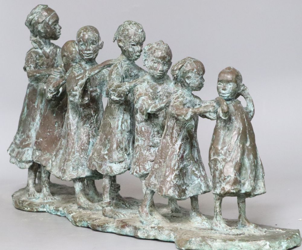 Lucy Poett (b.1942). A bronze of Seven South children in a line, signed, height 29cm width 58cm